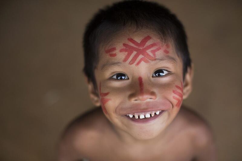 A boy smiles as he looks up to the camera, in the Tatuyo indigenous community near Manaus, Brazil. Manaus is one of the host cities for the 2014 World Cup in Brazil. Felipe Dana / AP 