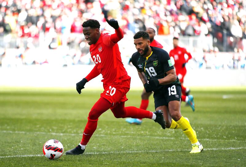 Canada forward Jonathan David controls the ball against Adrian Mariappa of Jamaica. AFP