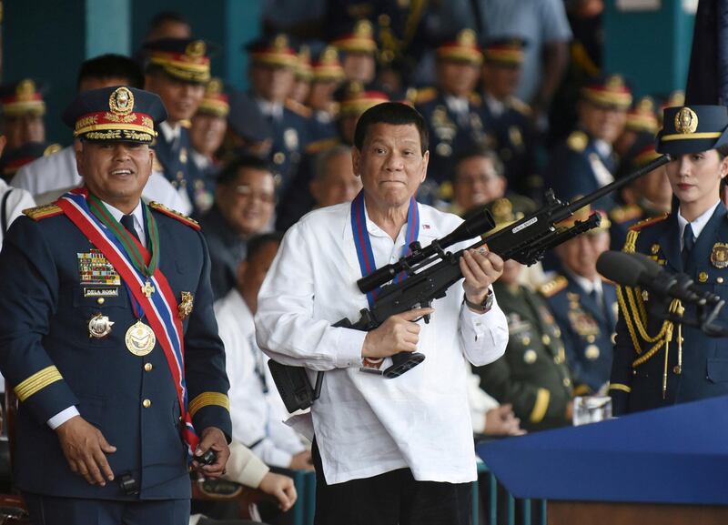 Philippine President Rodrigo Duterte holds a Galil sniper rifle next to outgoing National Police Chief Ronald Bato Dela Rosa during a handover ceremony in Camp Crame, Quezon City, Manila. Reuters