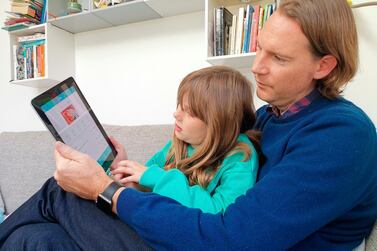 Paddy Kelly and his daughter use gohenry, a digital banking apps for children. A wave of digital pocket money apps that come with prepaid cards are new tools for financial education as money increasingly goes digital. Photo: AP 