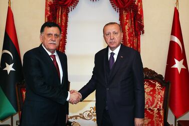 Recep Tayyip Erdogan, right, shakes hands with GNA's Fayez Al Sarraj during their meeting in Istanbul last month. EPA