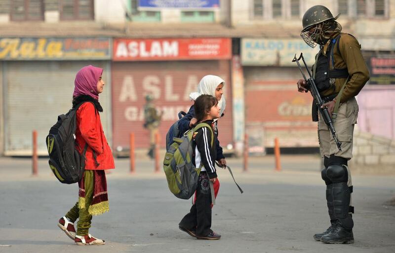 Kashmiri residents walk past Indian troopers standing guard during curfew and restrictions in downtown Srinagar as the unrest in Kashmir entered its 126th day on November 11, 2016. More than 90 civilians have been killed and thousands injured during the latest protests against Indian rule, sparked by the killing on July 8 of a popular rebel leader of Hizbul Mujahieed during a gunfight with Indian soldiers. Kashmir has been divided between India and Pakistan since their independence from British rule in 1947. Both claim the territory in full. Tauseef Mustafa / Agence France-Presse