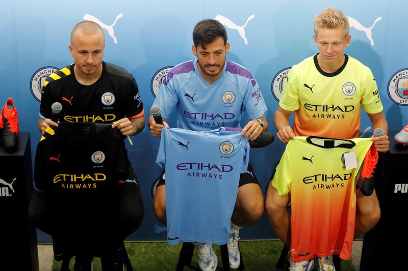 David Silva, centre, poses with teammates Angelino, left, and Oleksandr Zinchenko during a promotional event in Hong Kong. Reuters
