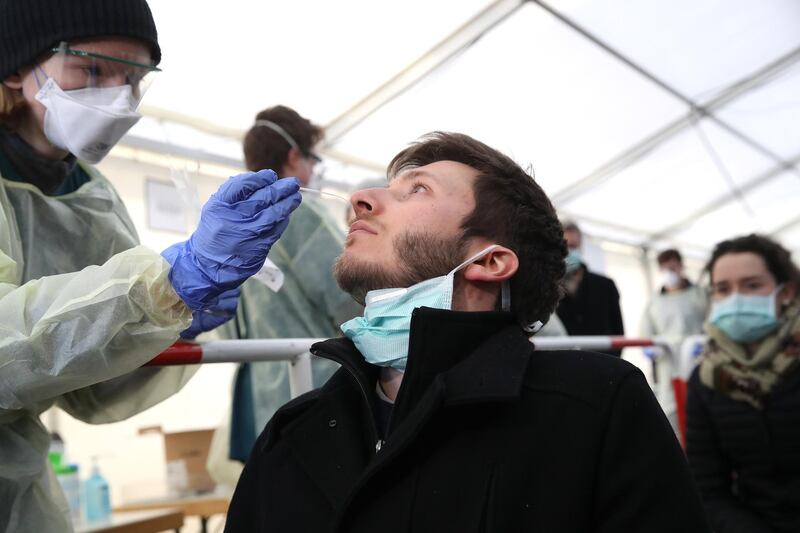 Medical personnel demonstrate taking nose and throat mucous samples for coronavirus testing in Munich, Germany. Getty Images
