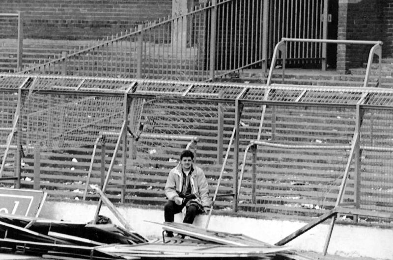 FILE - In this April 15, 1989 file photo a lone soccer supporter sits by the damaged fencing at Hillsborough Stadium, in Sheffield, England. British prosecutors on Wednesday June 28, 2017, are set to announce whether they plan to lay charges in the deaths of 96 people in the Hillsborough stadium crush _ one of Britain’s worst-ever sporting disasters. (AP Photo, File)