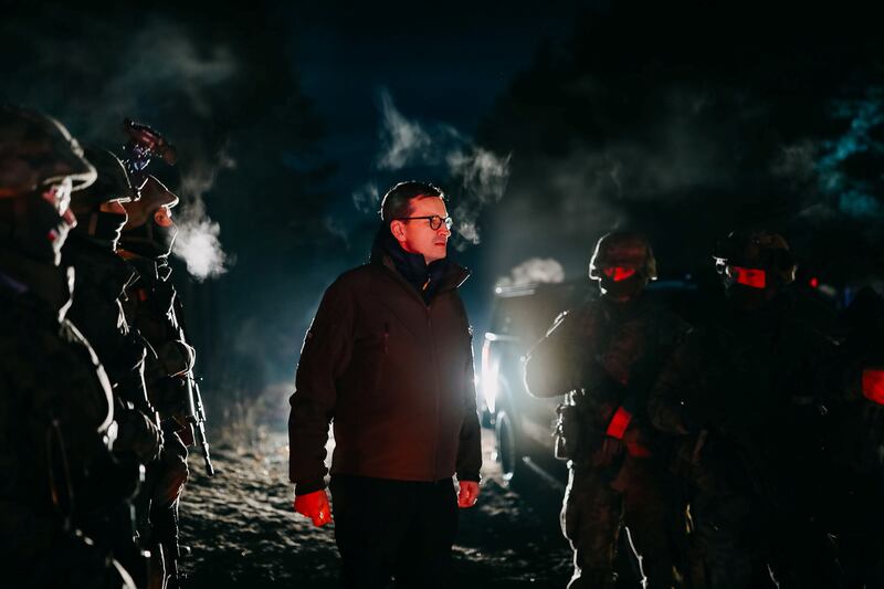 Poland's Prime Minister Mateusz Morawiecki visits the scene near the border, outside the Polish town of Krynki. Reuters