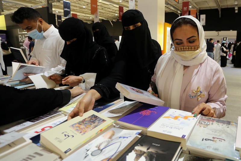 Saudi women look through books at the Riyadh International Book Fair.