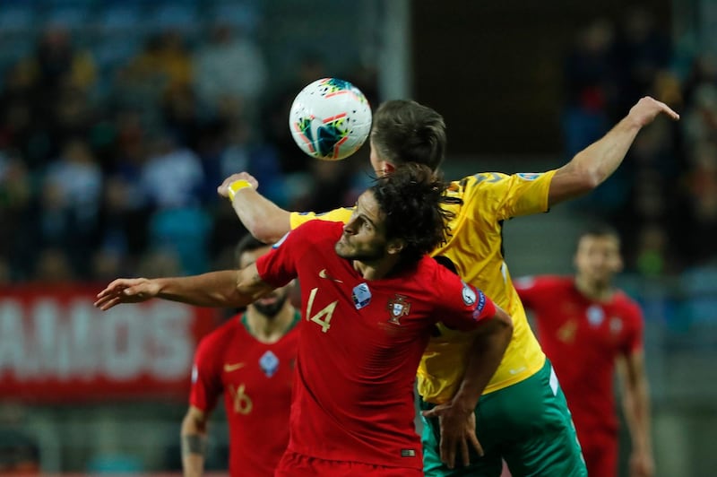 Portugal's Goncalo Paciencia, left, vies for the ball with Lithuania's Saulius Mikoliunas. AP
