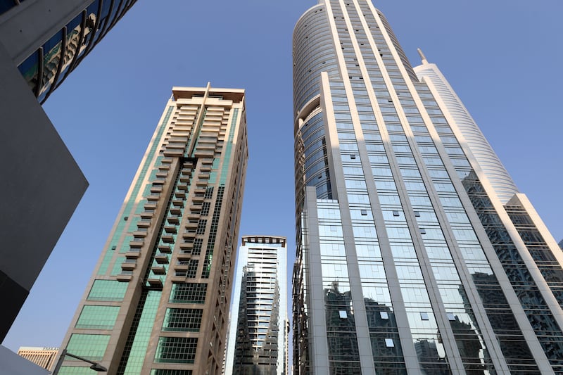 JLT's shimmering buildings are playing a role in keeping temperatures down, experts suggest. Chris Whiteoak / The National