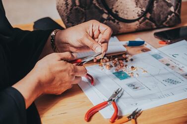 A student works with beads as part of the Piaget Design Competition Al Ula. Courtesy Piaget