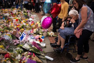People leave flowers in Manchester after the bombing at an Ariana Grande concert that killed 22 people. AP 