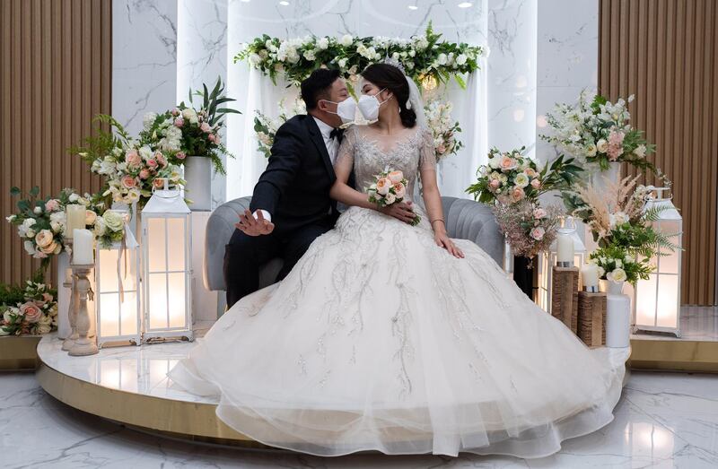 South Korean groom Chang Seung-yun and his Vietnamese bride Nguyen Thi Ut pose a kiss during a wedding ceremony amid the coronavirus pandemic in Seoul, South Korea.  EPA