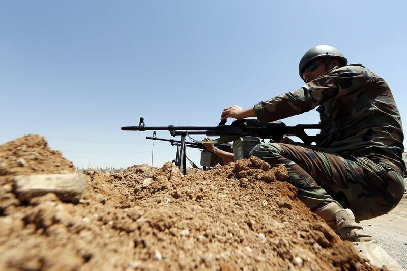Peshmerga fighters from Iraq's autonomous Kurdish region take positions in the town of Al Muafakiya on June 14, 2014. Karim Sahib / AFP Photo

