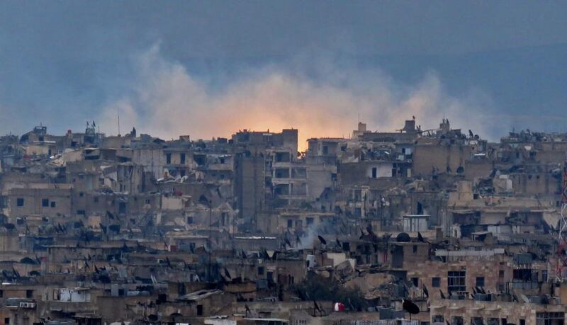 Smoke and flames rising from buildings in Aleppo's southeastern Al Zabdiya neighbourhood following government strikes on December 14, 2016. AFP