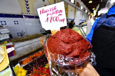 A shopkeeper shows a plate of Tunisian harissa at the central market of the capital Tunis. AFP