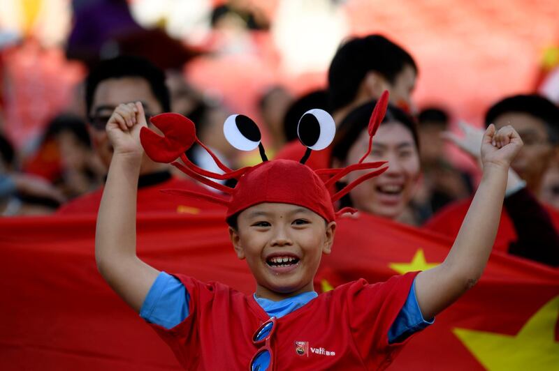 A China supporter cheers ahead of the 2019 AFC Asian Cup group C football match between Philippines and China at the Mohammed Bin Zayed Stadium in Abu Dhabi. AFP