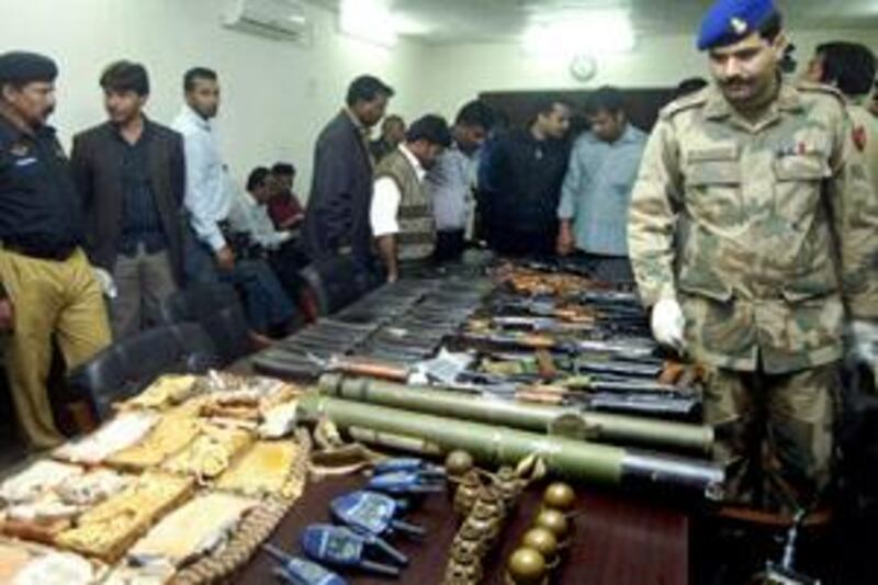 Pakistani security officials display ammunition recovered near and at the site of the shooting attack on the Sri Lankan cricket team, in Lahore March 3, 2009. Around a dozen gunmen attacked the team's bus on Tuesday with rifles, grenades and rockets, wounding six players and a British assistant coach and killing at least eight Pakistanis. Picture taken on March 3, 2009.   REUTERS/Stringer       (PAKISTAN) BEST QUALITY AVAILABLE *** Local Caption ***  ISL02_CRICKET PAKIS_0304_11.JPG