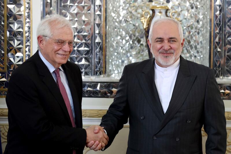 FILE - In this Monday, Feb 3, 2020, file photo, Iranian Foreign Minister Mohammad Javad Zarif, right, and European Union foreign policy chief Josep Borrell, shake hands for journalists prior to their meeting, in Tehran, Iran. Now that Britain has left the bloc, the EU hopes to find more time concentrate on its foreign policy. (AP Photo/Ebrahim Noroozi, File)
