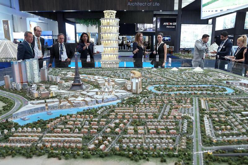 Visitors look at the model of Falconcity of Wonders. Pawan Singh / The National