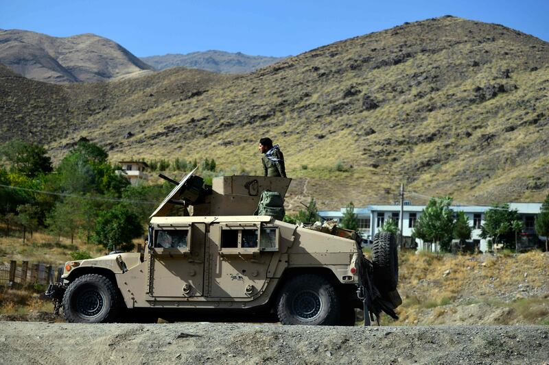 Afghan security forces patrol on humvee vehicle along a road in Bazarak town of Panjshir province.