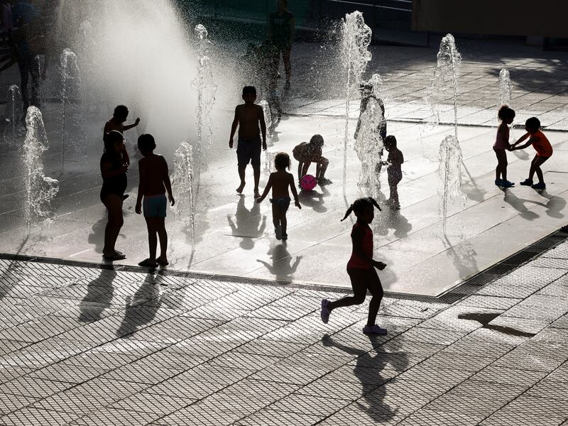 Children play on water jets at a public square on a very hot afternoon in Madrid, Spain. Getty Images