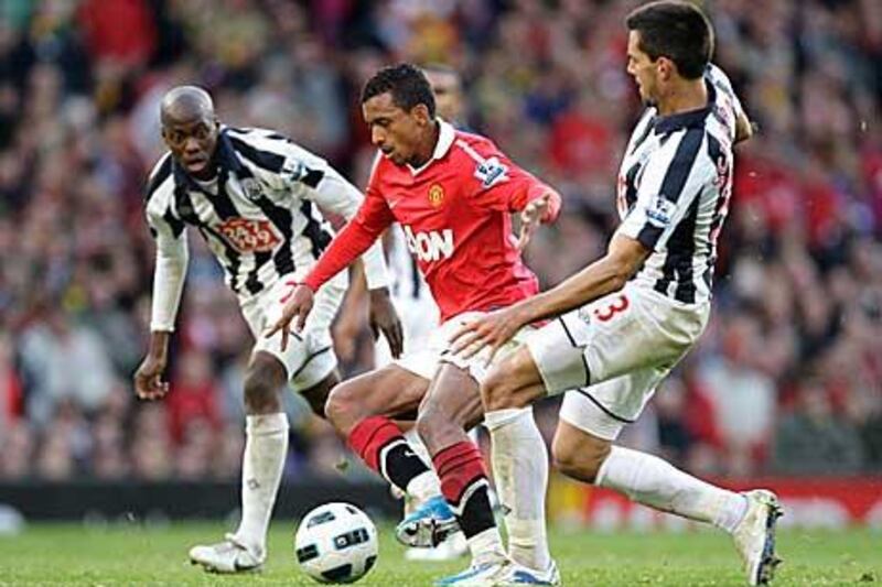 Nani, the Manchester United winger, dribbles his way past West Bromwich Albion’s Paul Scharner as United threw away a two-goal lead against the visitors yesterday.
