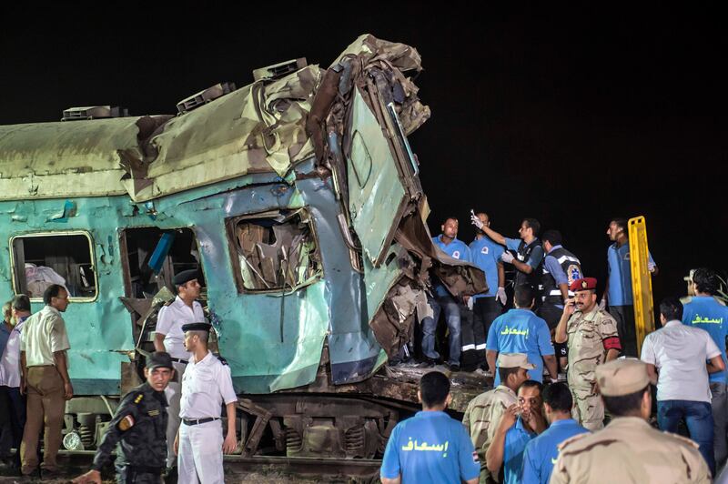 Officials and emergency personnel remove the wreckage of a collision between two trains near Khorshid station in Alexandria. Khaled Desouki / AFP
