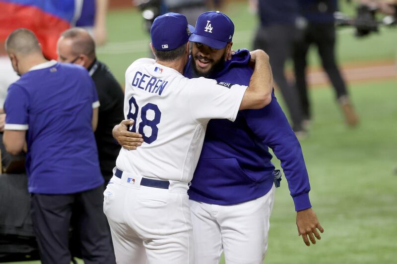 Kenley Jansen and coach Bob Geren of the Los Angeles Dodgers celebrate. AFP