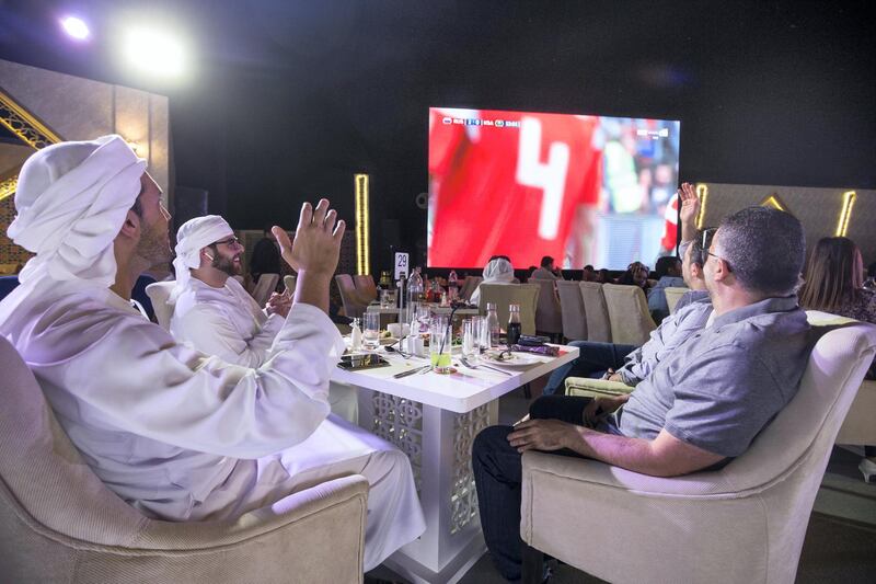 ABU DHABI, UNITED ARAB EMIRATES, 14 June 2018 - Football fans watching the games between Saudi and Russia at Sofitel Corniche tent in Abu Dhabi.  Leslie Pableo for The National story by Anna Zacharias