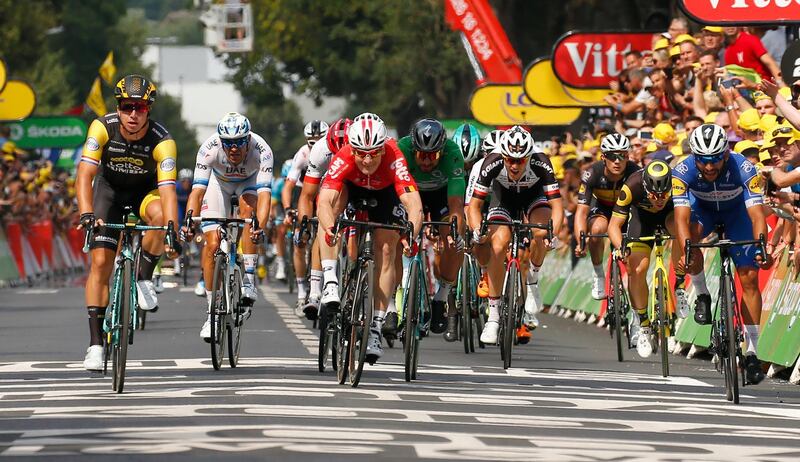Netherlands' Dylan Groenewegen, left, Germany's Andre Greipel, center, sprint to cross the finish line to win the eight stage of the Tour de France cycling race over 181 kilometers (112.5 miles) with start in Dreux and finish in Amiens, France, Saturday, July 14, 2018. (AP Photo/Peter Dejong)