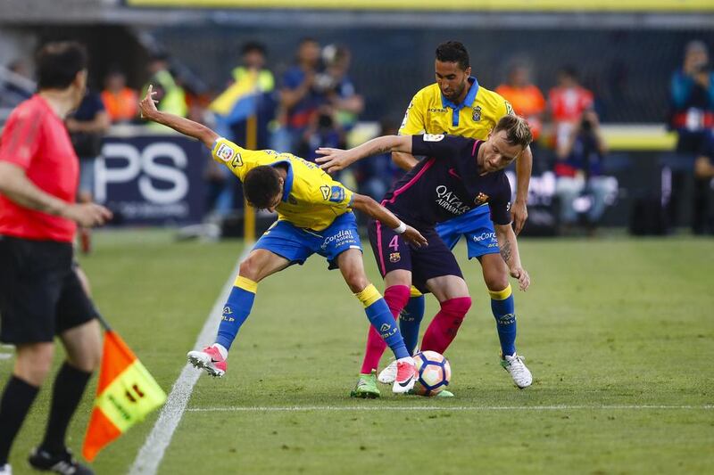 Barcelona midfielder Ivan Rakitic duels for the ball against Las Palmas’ Helder Lopes. Lucas de Leon / AP Photo