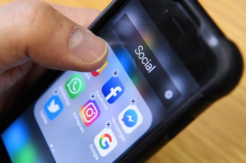 A man holds a smart phone with the icons for the social networking apps Facebook, Instagram and Twitter seen on the screen in Moscow on March 23, 2018.
A public apology by Facebook chief Mark Zuckerberg, on March 22, 2018 failed to quell outrage over the hijacking of personal data from millions of people, as critics demanded the social media giant go much further to protect privacy. / AFP PHOTO / Kirill KUDRYAVTSEV