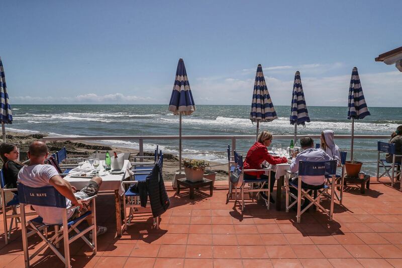 Guest sit on a terrace after the reopening of the sea view restaurant as part of phase 2 of the coronavirus Covid-19 emergency, in Fregene, south of Rome, Italy.  EPA