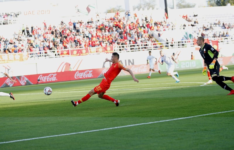 Yu Dabao slots the ball into an empty net for China to take the lead, EPA