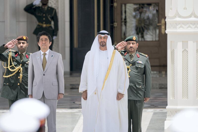 ABU DHABI, UNITED ARAB EMIRATES - April 30, 2018: HH Sheikh Mohamed bin Zayed Al Nahyan, Crown Prince of Abu Dhabi and Deputy Supreme Commander of the UAE Armed Forces (R) and HE Shinzo Abe, Prime Minister of Japan (L), stand for the national anthem during a reception at the Presidential Palace.

( Rashed Al Mansoori / Crown Prince Court - Abu Dhabi )
---
