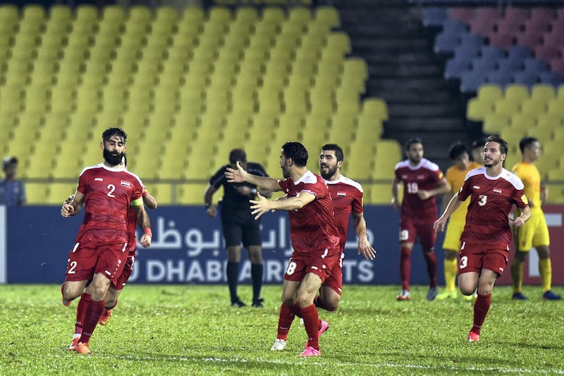 MALACCA, MALAYSIA - JUNE 13: Ahmad Al Saleh (L) of Syria celebrates after scoring the equaliser in the final minute during the 2018 FIFA World Cup Asian Qualifier Group A Final Round match between Syria and China at Hang Jebat Stadium on June 13, 2017 in Malacca, Malaysia.  (Photo by Stanley Chou/Getty Images)