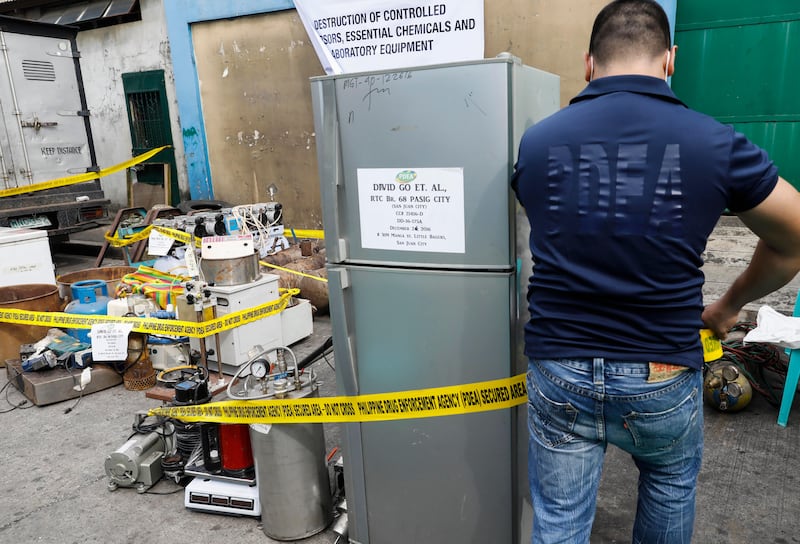 epa06260164 A personnel of the Philippine Drug Enforcement Agency (PDEA) puts caution tape around seized equipment for the manufacture of illegal drugs, before a destruction procedure in Valenzuela City, north of Manila, Philippines, 12 October 2017. The PDEA destroyed seized chemicals, materials and equipment for manufacturing illegal drugs worth some 10.7-million pesos (176,000 euro) as part of an anti-illegal drugs campaign. Philippine President Rodrigo Duterte issued a memorandum dated 10 October giving the PDEA sole responsibility to lead anti-illegal drugs operations in the country, effectively halting operations headed by the Philippine National Police and other government agencies concerned.  EPA/ROLEX DELA PENA