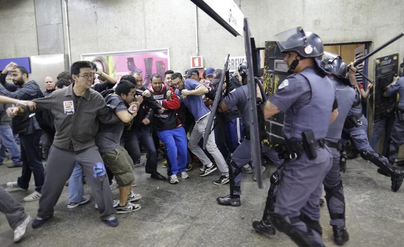 Subway train operators, along with some activists, clash with police at the Ana Rosa metro station on the second day of their metro strike in Sao Paulo, Brazil, on June 6, 2014. Nelson Antoine / AP Photo