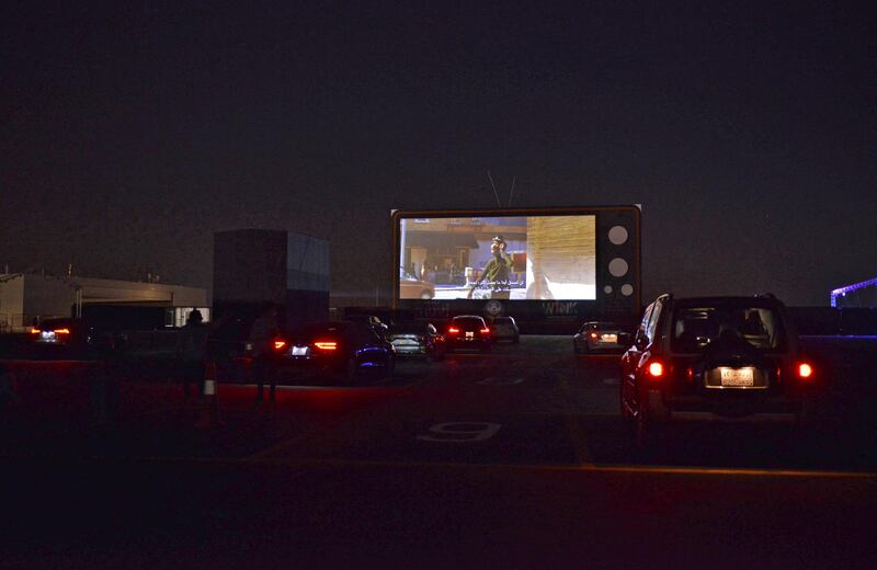 Vehicles take their place in the first drive-in cinema in the Saudi capital Riyadh which can accommodate up to 150 vehicles while maintaining social distancing measures amidst the Covid-19 pandemic, on January 26, 2021. (Photo by FAYEZ NURELDINE / AFP)