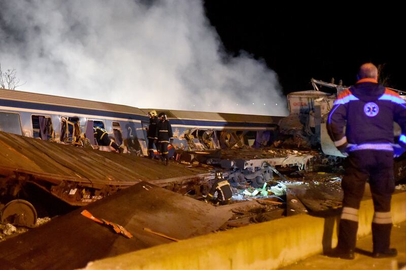 Firefighters work to extricate passengers from derailed train carriages in Greece. EPA