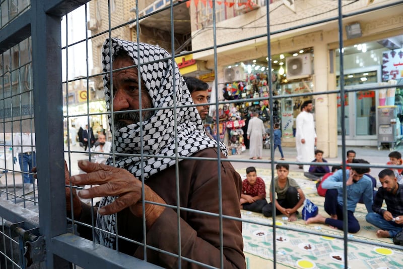 People gather to break their fast during a communal iftar on a street in the central Iraqi city of Najaf. Reuters