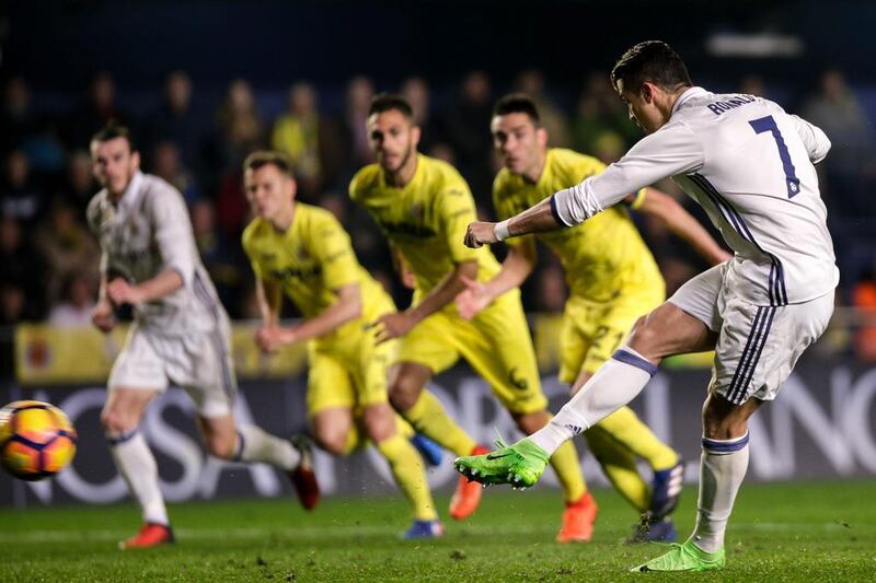 Real Madrid’s Portuguese forward Cristiano Ronaldo, right, scores against Villarreal. Biel Alino / AFP