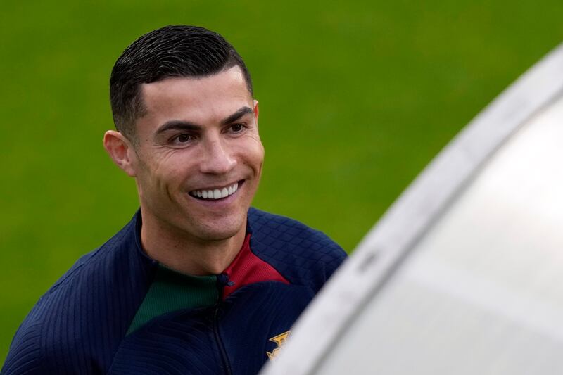 Cristiano Ronaldo smiles as he arrives for a team training session in Oeiras, outside Lisbon. AP Photo