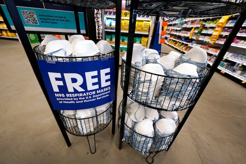 A product stall filled with free N95 respirator masks, provided by the US Department of Health and Human Services, sits outside the pharmacy at a Jackson, Mississippi, Kroger grocery store. AP