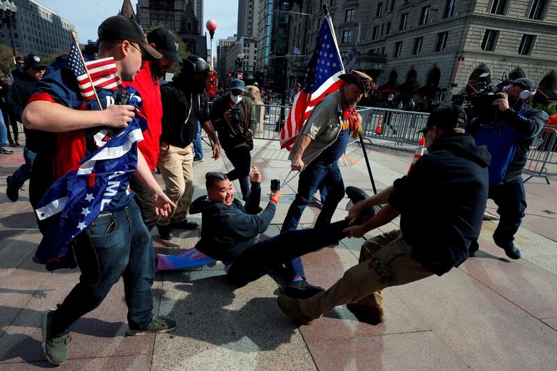 Pro-Trump demonstrators remove a counter-protester during a rally in Boston, Massachusetts on October 18. Reuters