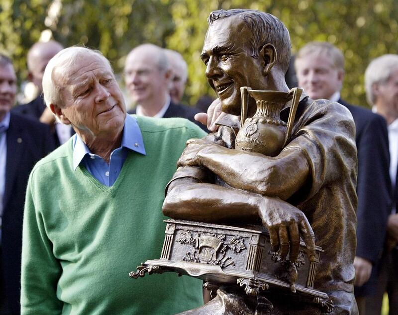 Golf legend Arnold Palmer, left, looks at a statue of himself commemorating the 50th anniversary of his first PGA tour win in 1955 at the Weston Golf and Country Club in Toronto, Canada, on September 13, 2005. Mike Cassese / Reuters