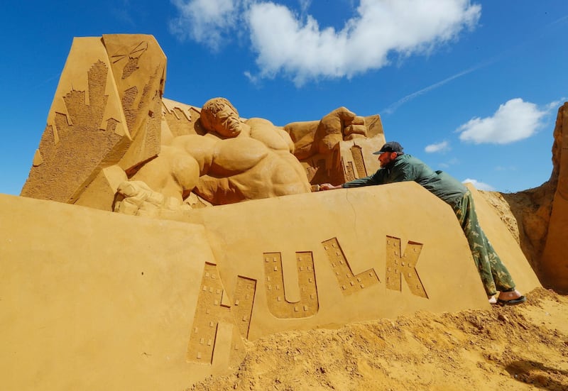 A sand carver works on an Incredible Hulk sand sculpture. Yves Herman / Reuters