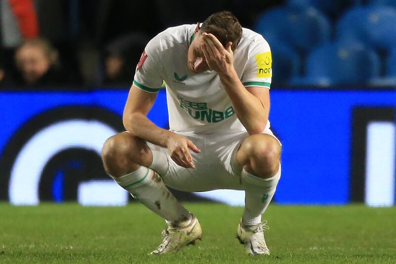 Newcastle striker Chris Wood looks downcast at the final whistle. AFP