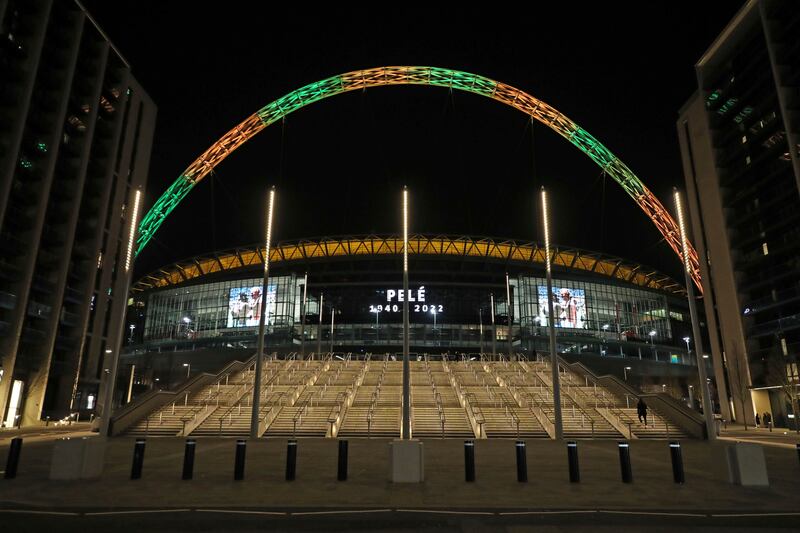 Wembley Stadium's arch is lit up in the colours of Brazil following the death of Pele. PA