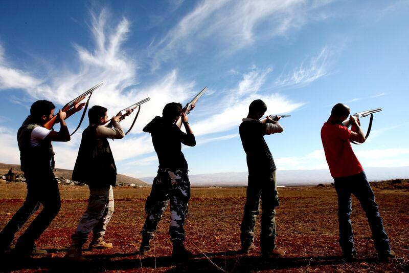 Lebanese hunters aim at a flock of birds in the village of Shlifa in Lebanon's eastern Bekaa valley on November 9, 2008. Lebanon is a major passage for migratory birds where hunters wait for the season to practice their sport. Hunting was banned in 1994 for five years after pressure from Western countries to protect migratory birds but the absence of regulations, the ambiguity of hunting laws, and the lack of serious law enforcement, has resulted in rampant, unregulated hunting, which led to the extinction of a number of local species. AFP PHOTO/JOSEPH BARRAK / AFP PHOTO / JOSEPH BARRAK